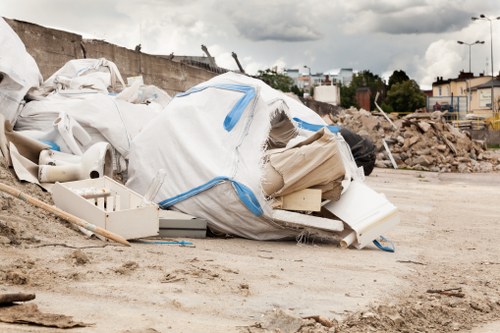 Workers using lifting equipment and sorting recyclables during a clearance