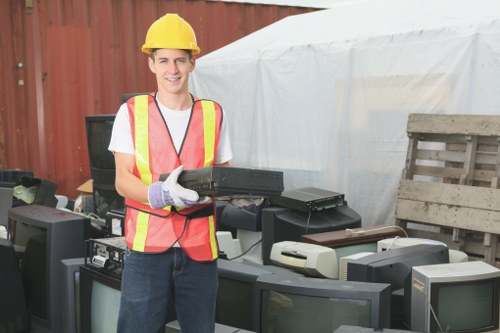 Volunteers loading donated office furniture for charity reuse